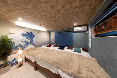 a bedroom with a large bed and a wall mural at 3-minute walk from Nishi-Shinjuku Station 100square meters Entire Private House 4LDK in Tokyo