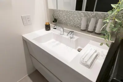 a bathroom with a white sink and a mirror at 3-minute walk from Nishi-Shinjuku Station 100square meters Entire Private House 4LDK in Tokyo