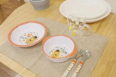 a table with three plates and a fork and knife at Dori Dori House Sumida in Tokyo