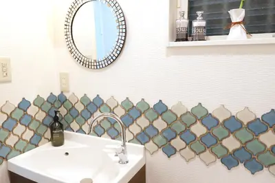 a bathroom with a sink and a mirror at Dori Dori House Sumida in Tokyo