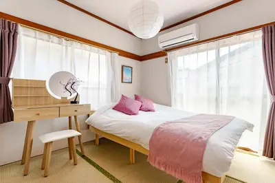 a bedroom with a bed and a desk and windows at ntb\u5800\u52072\u4e01\u76eeESTA 2 in Tokyo