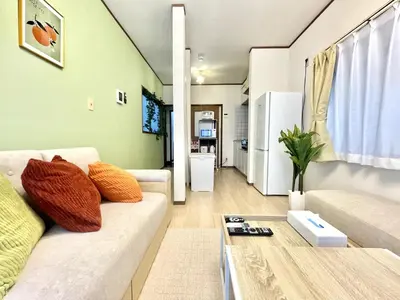 a living room with a couch and a table at ntb\u5800\u52072\u4e01\u76eeESTA 2 in Tokyo