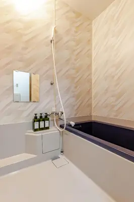 a bathroom with a shower with bottles of wine at ntb\u5800\u52072\u4e01\u76eeESTA 2 in Tokyo