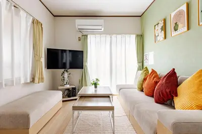a living room with a couch and a tv at ntb\u5800\u52072\u4e01\u76eeESTA 2 in Tokyo