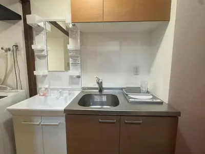 a bathroom with a sink and a mirror at B&B 103 under the clear sky Go straight to Narita 8 minutes on foot from Kinshicho Station 1 minute on foot from Asakusa and Skytree 50 minutes from Disneyland 1 minute from Monopolis in Tokyo