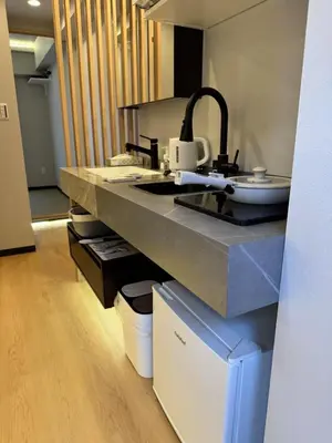 a kitchen with a counter top with a sink at Minshuku 203 under the clear sky 8-minute walk from Kinshicho Station direct line to Narita Airport 50-minute walk from Disneyland and 1-minute walk from the mall in Tokyo