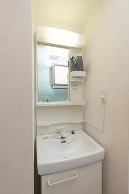 a bathroom with a white sink and a mirror at Clear Sky Guesthouse 305 Direct to Narita Airport, 8-minute walk from Kinshicho Station, within walking distance of Asakusa and Clear Sky Tower, 50 minutes to Disneyland, 1 minute to the mall in Tokyo