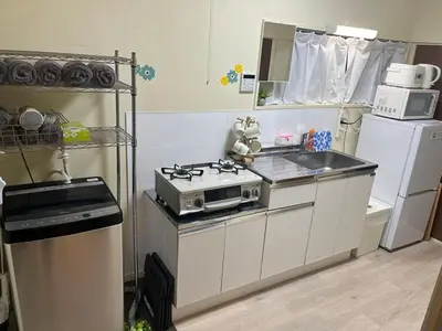 a small kitchen with a stove and a sink at NEW OPEN Available for 10 people 1 line to airport in Tokyo