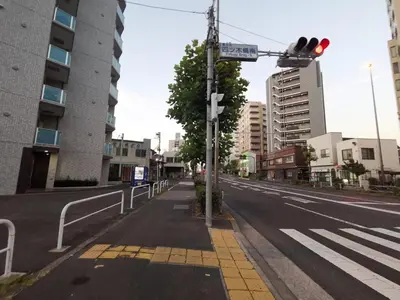 an empty city street with a traffic light and a street sign at NEW OPEN Available for 10 people 1 line to airport in Tokyo