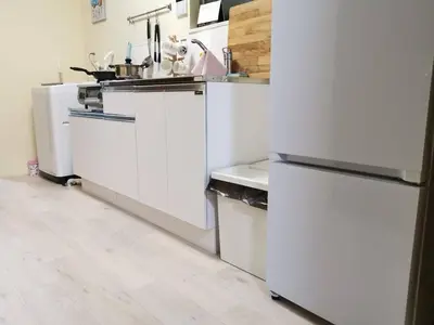 a kitchen with white appliances and a wooden floor at NEW OPEN Available for 10 people 1 line to airport in Tokyo