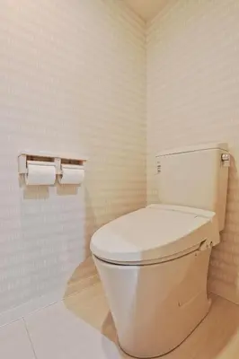 a bathroom with a toilet and two rolls of toilet paper at v close to Noagata 15 min to Shinjuku station in Tokyo