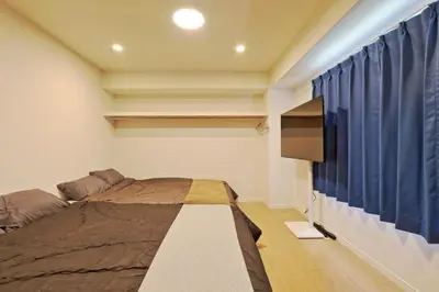 a bedroom with a bed and a tv in it at v close to Noagata 15 min to Shinjuku station in Tokyo