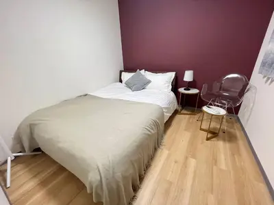 a small bedroom with a bed and a chair at \u65e5\u66ae\u91ccMori House A in Tokyo