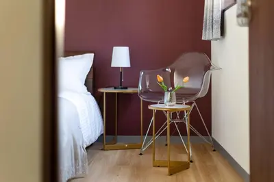 a bedroom with a chair and a bed and a lamp at \u65e5\u66ae\u91ccMori House A in Tokyo