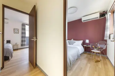 a bedroom with a bed and a mirror at \u65e5\u66ae\u91ccMori House A in Tokyo