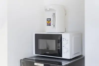 a microwave and a blender sitting on top of a refrigerator at \u65e5\u66ae\u91ccMori House A in Tokyo