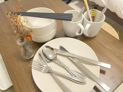 a table with a white plate and silver utensils at \u30b5\u30af\u30e9\u30b7\u30e3\u30c9\u30a6\u9280\u5ea7502 in Tokyo