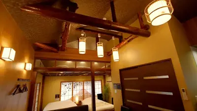 a room with a barn door and a room with a light at \u304a\u5bbf\u5be7\u3005OyadoNene\u677f\u6a4b \u6c60\u888b3\u5206\u65b0\u5bbf9\u5206 in Tokyo