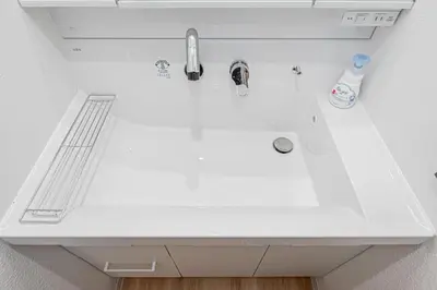 a white kitchen sink with a faucet at \u65e5\u66ae\u91ccMori House B in Tokyo