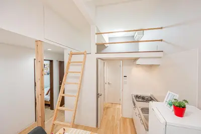 a kitchen with a ladder in a small apartment at \u65e5\u66ae\u91ccMori House B in Tokyo