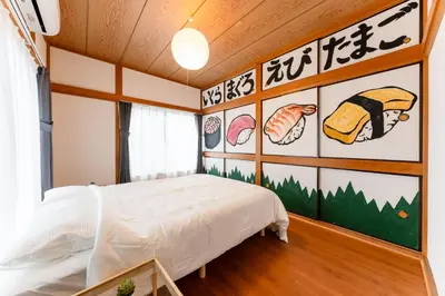 a bedroom with a bed and a wall with food illustrations at Sushi Art Hotel at Kamiisshiki\u5bff\u53f8\u30a2\u30fc\u30c8\u30db\u30c6\u30ebat\u4e0a\u4e00\u8272 in Tokyo