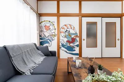 a living room with a couch and a table at Sushi Art Hotel at Kamiisshiki\u5bff\u53f8\u30a2\u30fc\u30c8\u30db\u30c6\u30ebat\u4e0a\u4e00\u8272 in Tokyo