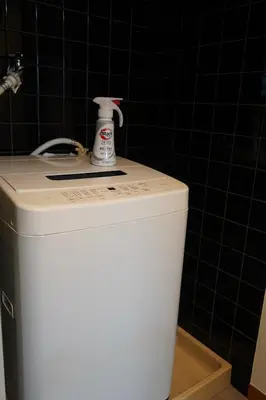 a white bottle of cleaner sitting on top of a toilet at \u6771\u4eac\u5927\u7530\u533a\u5e73\u548c\u5cf6\u30a2\u30d1\u30fc\u30c8\u30e1\u30f3\u30c8 in Tokyo
