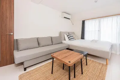 a small living room with a couch and a bed at 67Apt Shinkoiwa in Tokyo