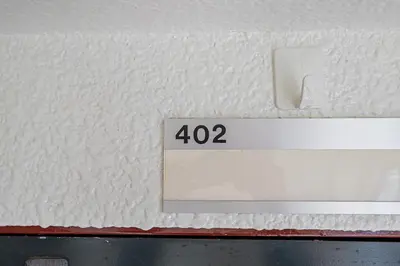 a sign on a wall with the number on it at 67Apt Shinkoiwa in Tokyo
