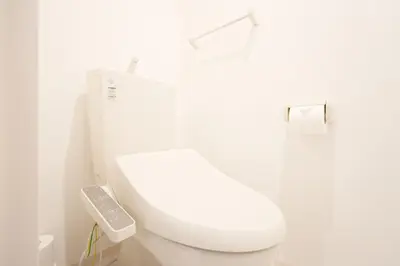 a bathroom with a white toilet with a remote control at Tell House in Tokyo