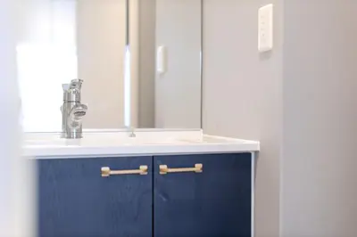 a bathroom with a sink and a mirror at Tell House in Tokyo