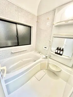 a white bathroom with a tub and a window at \u6e0b\u8c37\u533a\u306e\u4e00\u8ed2\u5bb6 80\u5e73\u7c73 3\u5bdd\u5ba46\u30d9\u30c3\u30c9 \u5e61\u30f6\u8c37\u99c5\u5f92\u6b695\u5206 \u65b0\u5bbf\u307e\u3067\u96fb\u8eca4\u5206 in Tokyo