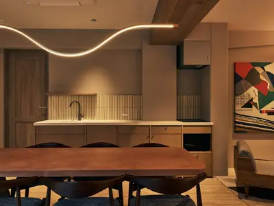 a dining room with a table and a kitchen at illi Mia Kinshicho in Tokyo