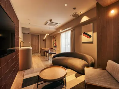 a living room with a couch and a table at illi Mia Kinshicho in Tokyo
