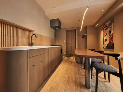 a kitchen with a wooden counter and a wooden table at illi Mia Kinshicho in Tokyo