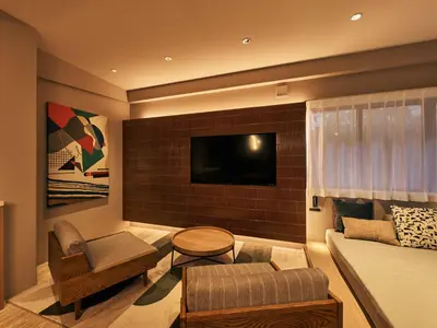 a living room with a couch and a tv at illi Mia Kinshicho in Tokyo