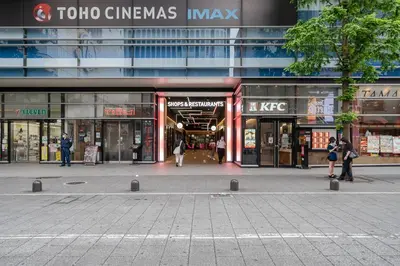 a building with people standing in front of a store at \u30ac\u30a4\u30a2\u6b4c\u821e\u4f0e\u753a\u58f1\u756a\u9928204 in Tokyo