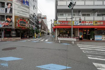 an empty street in an asian city with buildings at \u30ac\u30a4\u30a2\u6b4c\u821e\u4f0e\u753a\u58f1\u756a\u9928204 in Tokyo