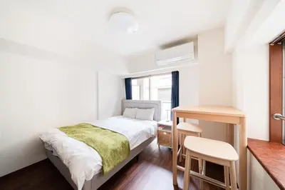 a small bedroom with a bed and a table at \u30ac\u30a4\u30a2\u6b4c\u821e\u4f0e\u753a\u58f1\u756a\u9928204 in Tokyo