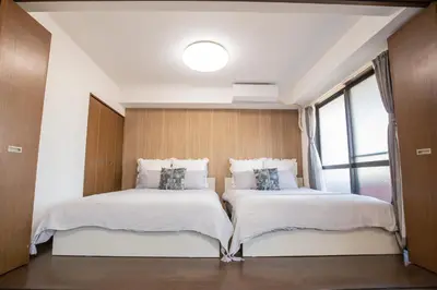 two beds in a room with a window at \u5317\u65b0\u5bbf\u5f92\u6b693\u5206 \u4ea4\u901a\u81f3\u4fbf \u4e0b\u753a\u30b0\u30eb\u30e1 \u5546\u5e97\u8857\u30b7\u30e7\u30c3\u30d4\u30f3\u30b0\u5bbf S02c in Tokyo