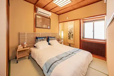 a bedroom with a large bed and a window at Hotel Ginnan in Tokyo