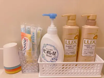 a white basket with four bottles of detergent and toothpaste at Shinjuku House-1 in Tokyo