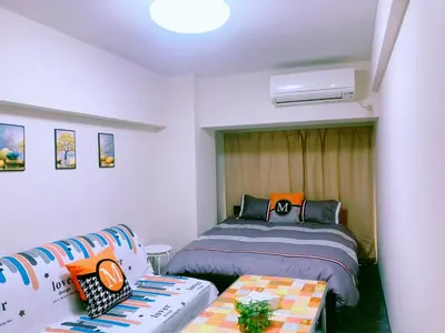a small bedroom with a bed and a couch at Shinjuku House-1 in Tokyo