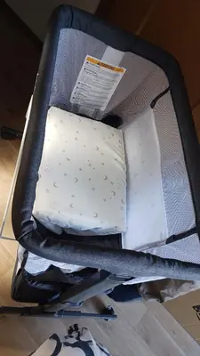 a suitcase with a pillow and papers in it at Jetset haneda 105 in Tokyo