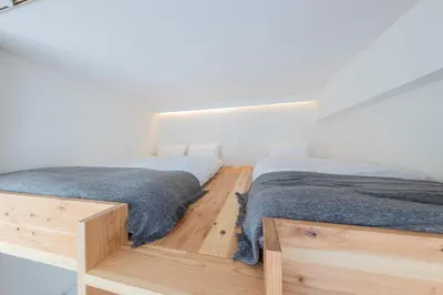 two beds sitting next to each other in a bedroom at \u30ea\u30bf\u30a4\u30f3\u4e2d\u4e95 in Tokyo