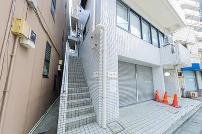 a staircase leading to a building with a garage at \u30ea\u30bf\u30a4\u30f3\u4e2d\u4e95 in Tokyo