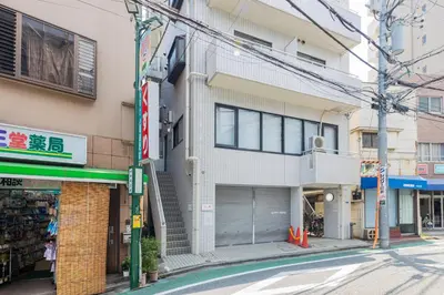 an apartment building with a garage on a street at \u30ea\u30bf\u30a4\u30f3\u4e2d\u4e95 in Tokyo