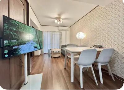 a living room with a table and a tv at Kitashinjuku 107-SJ0014 in Tokyo