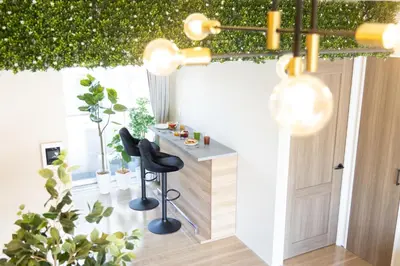 a room with a bar with two chairs and plants at Parkview, 3min by Train to Shibuya, 5min by Train to Shinjuku in Tokyo