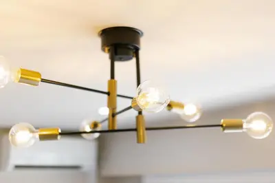 a black and gold chandelier hanging from a ceiling at Parkview, 3min by Train to Shibuya, 5min by Train to Shinjuku in Tokyo
